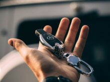 person holding Mercedes-Benz fob