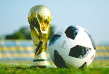gold-colored trophy and soccerball