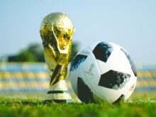 gold-colored trophy and soccerball