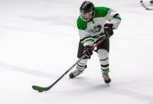 man in yellow and green ice hockey jersey t