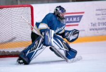 ice hockey goalie defending the goal