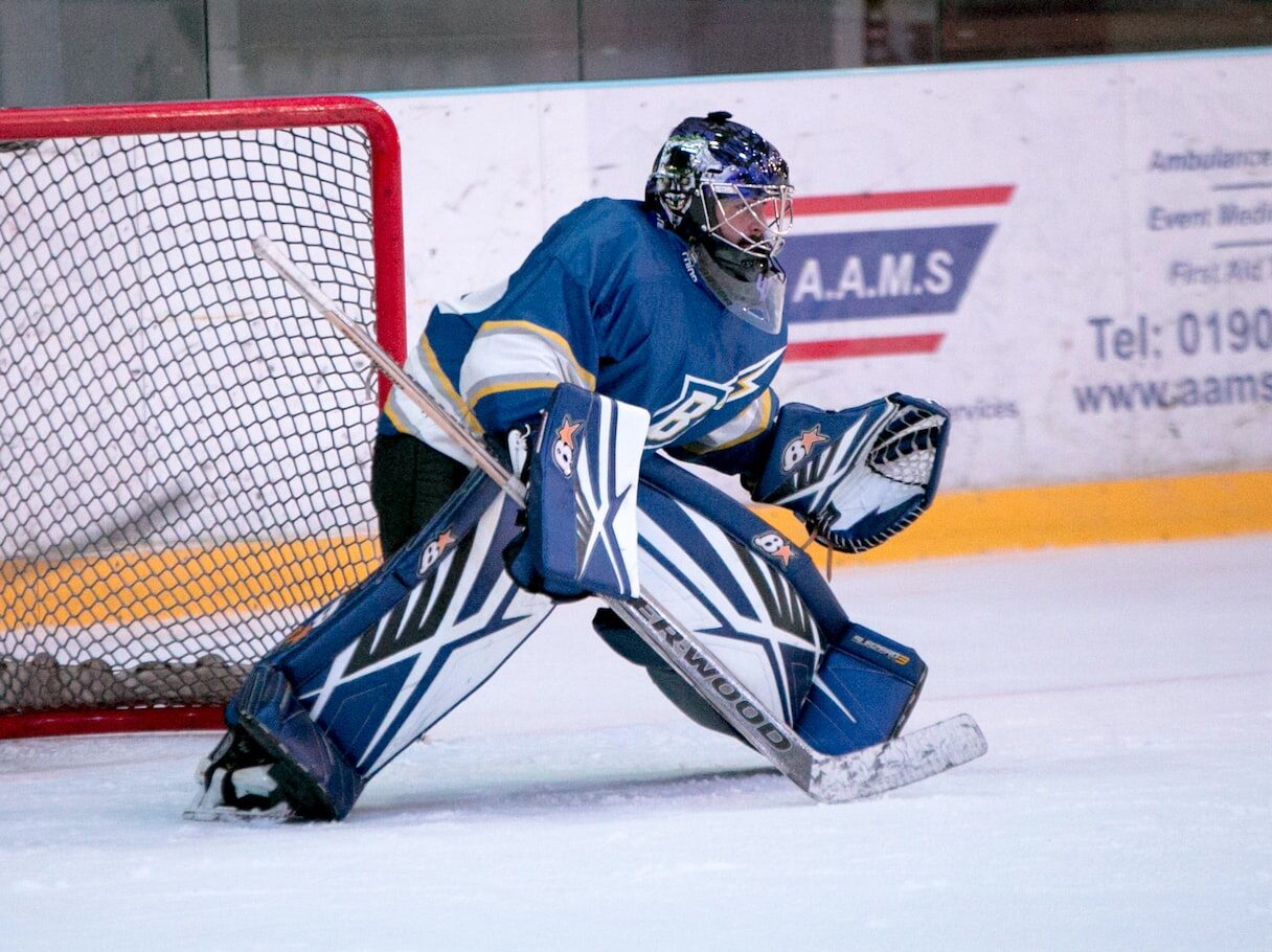 ice hockey goalie defending the goal