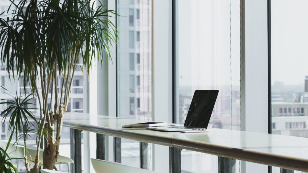 turned off laptop computer on top of brown wooden table