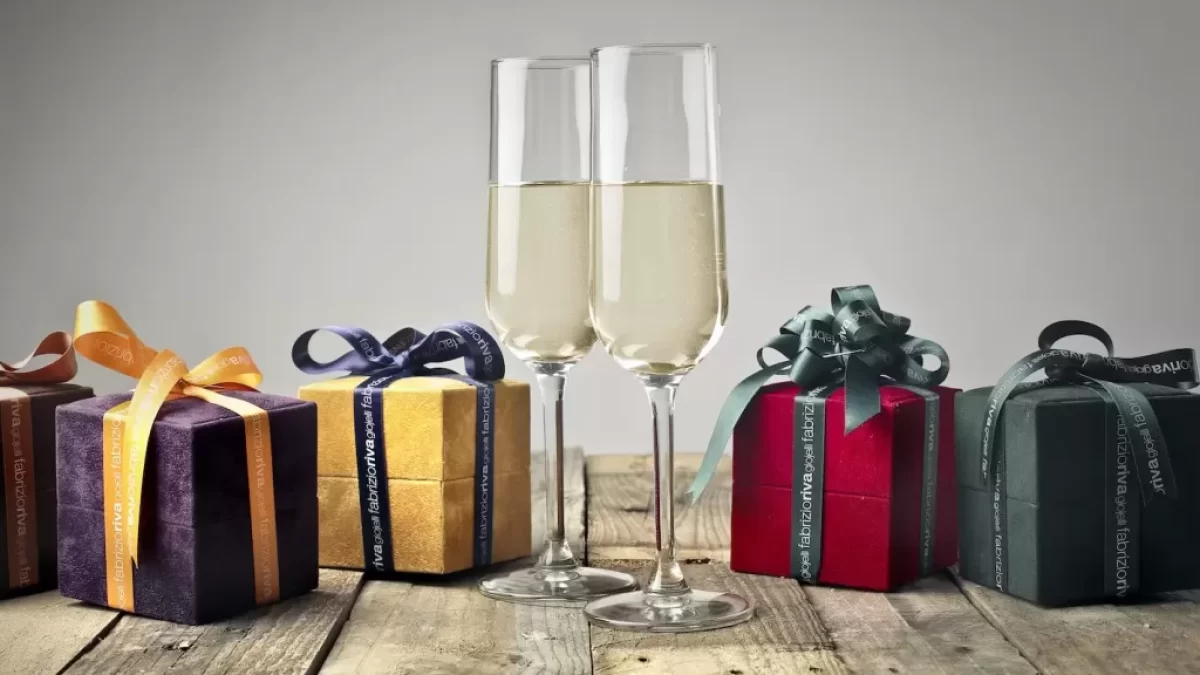 Five Assorted-color Gift Boxes and Two Footed Glasses on Top of Table