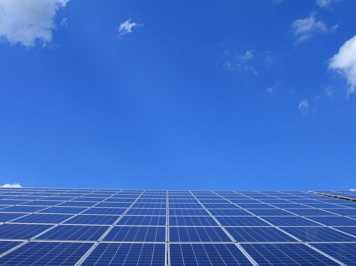 Blue Solar Panels Under Sunny Sky