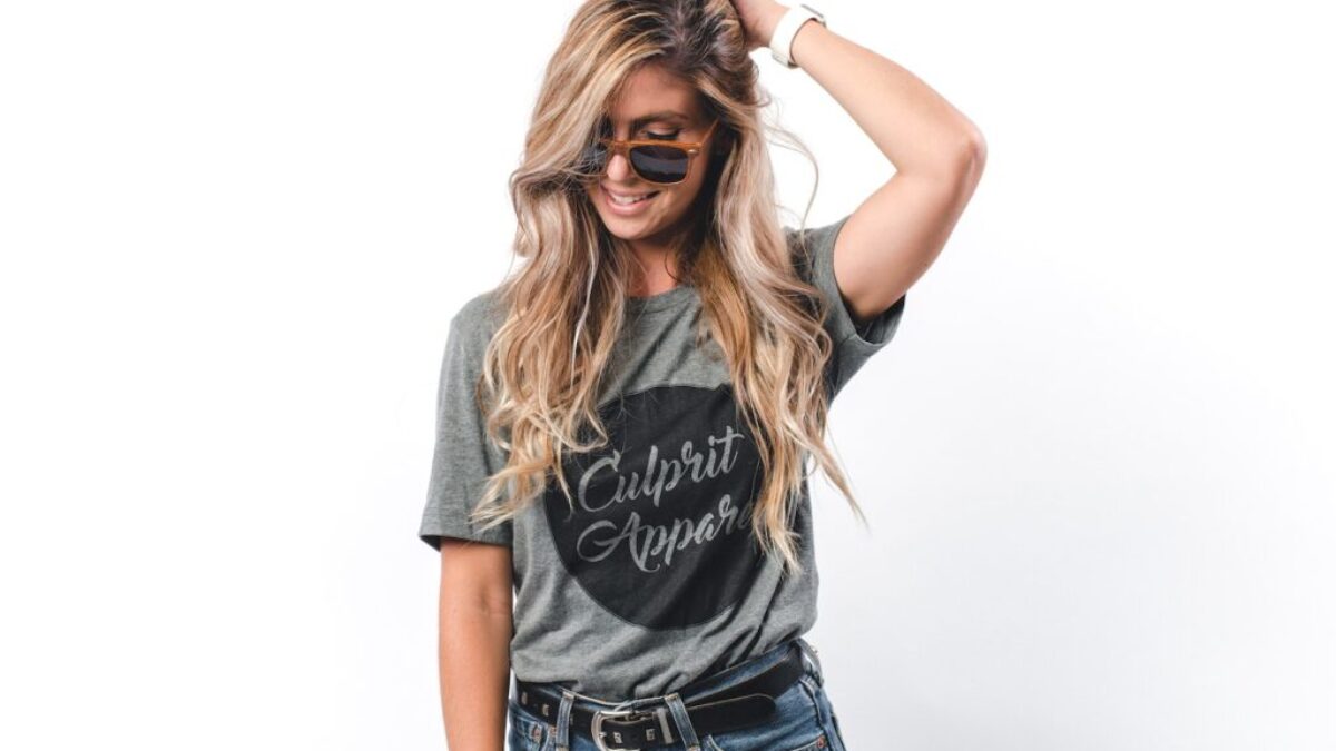 Woman Wearing Gray Shirt Holding Head