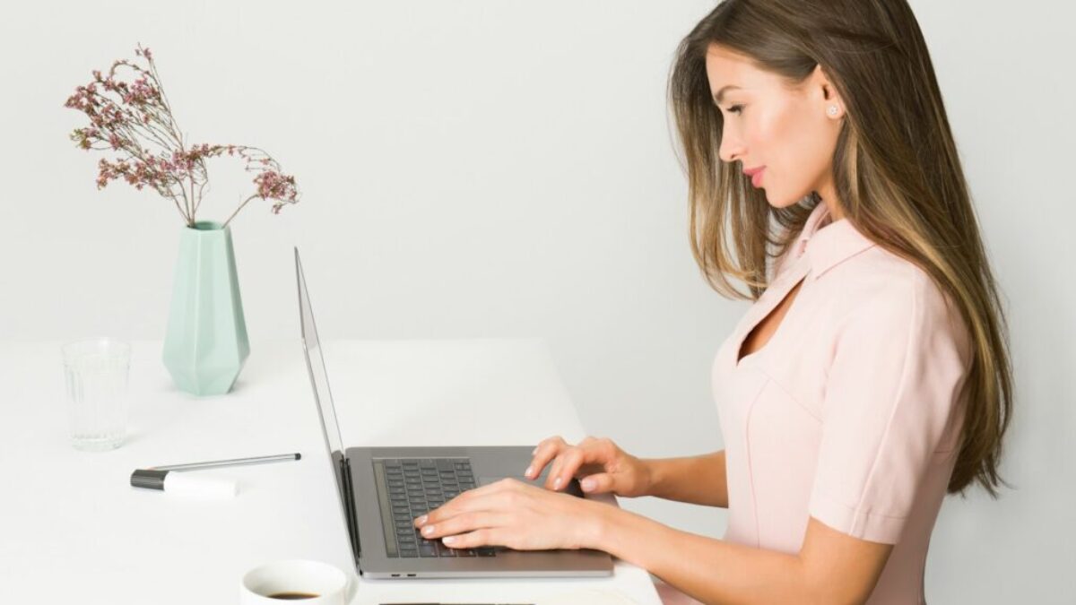woman sitting while using laptop