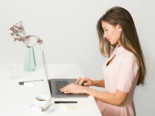 woman sitting while using laptop