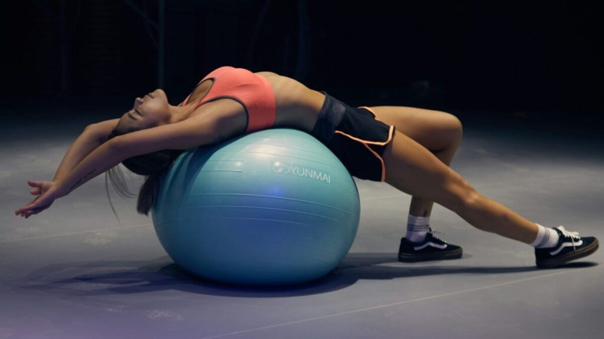 woman doing yoga on stability ball