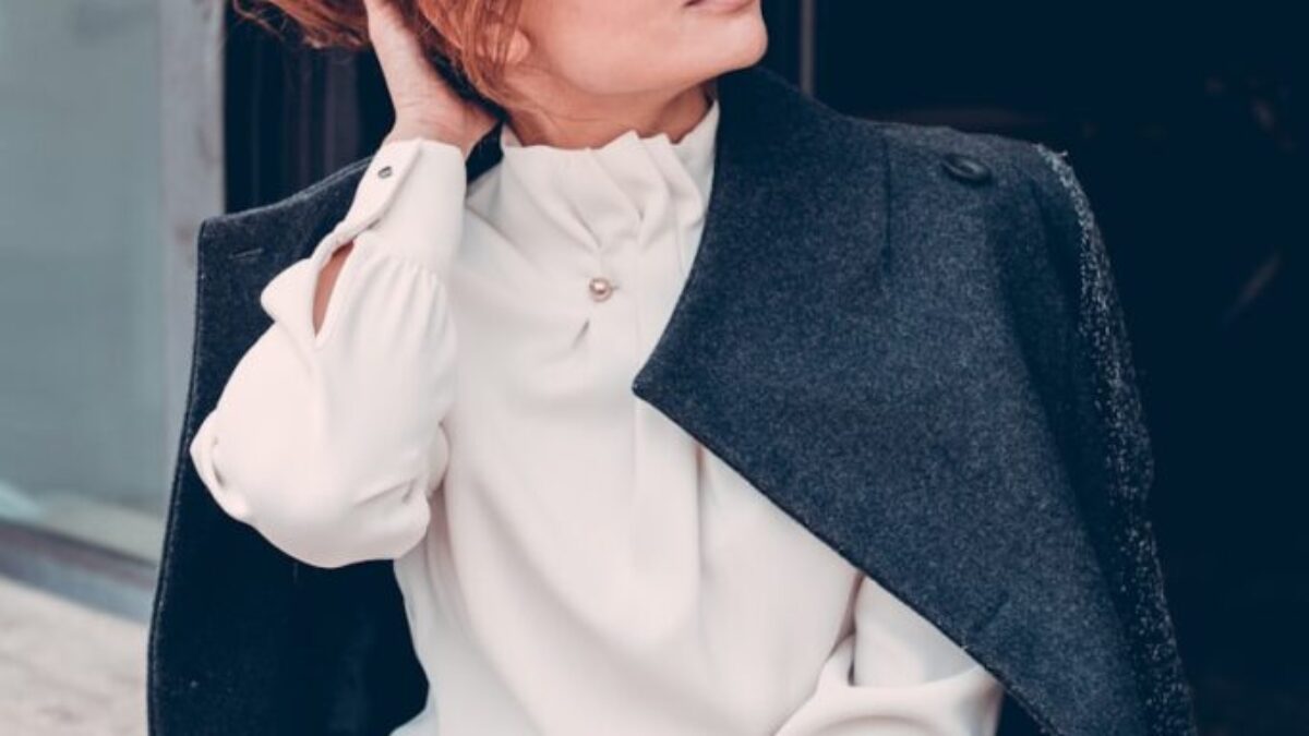 woman in black coat wearing black sunglasses