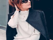 woman in black coat wearing black sunglasses