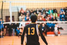 man wearing black 13 volleyball jersey