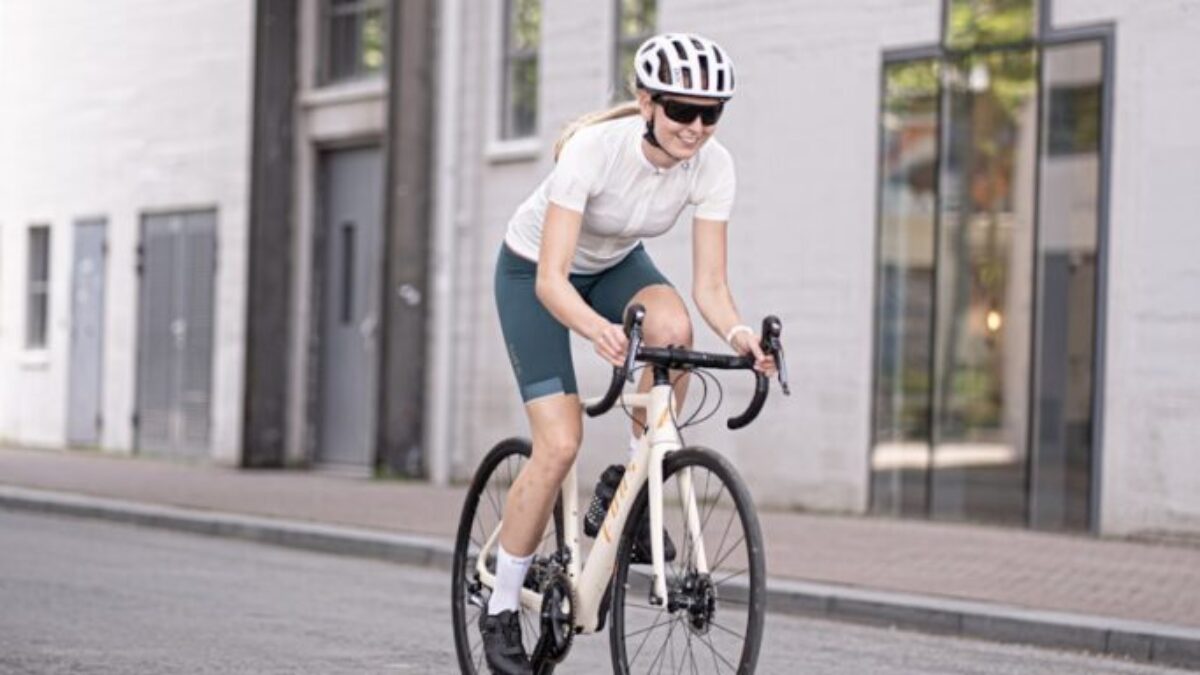 man in white t-shirt riding on bicycle during daytime