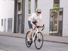 man in white t-shirt riding on bicycle during daytime