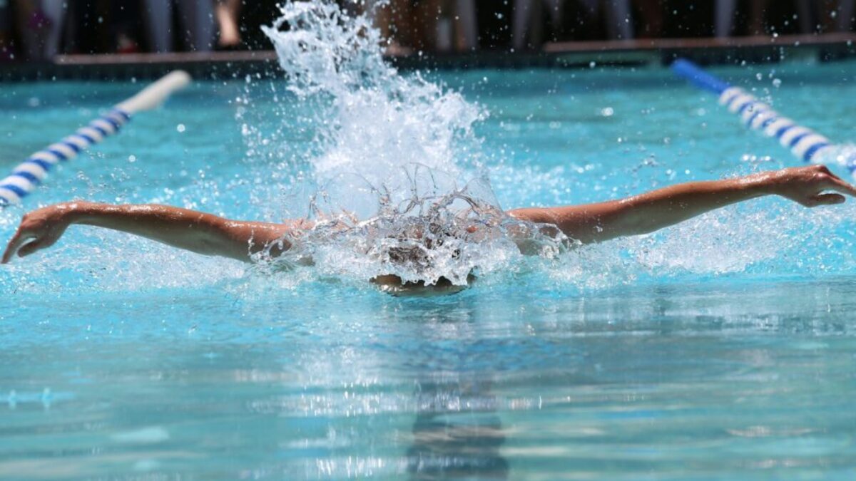 person in blue and white shorts in water