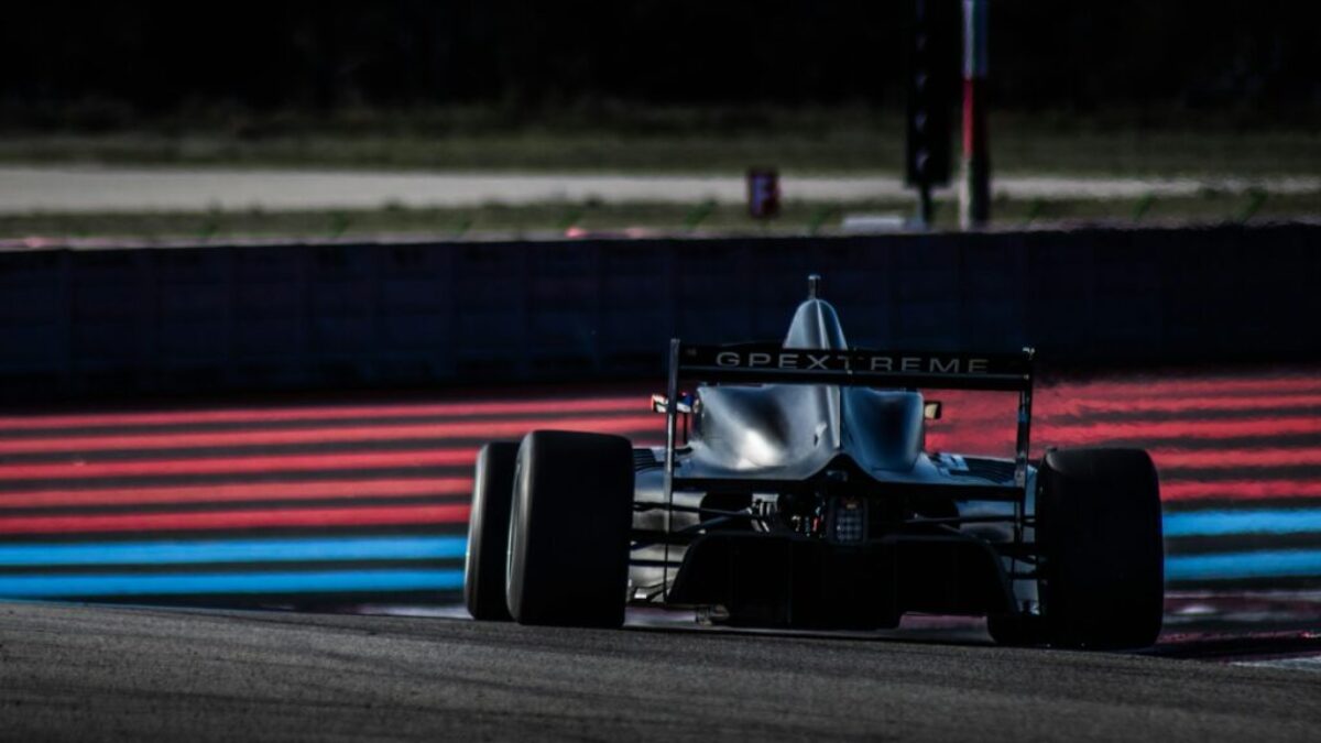 red and black f 1 race car on track during daytime