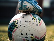 white and blue soccer ball on green grass field