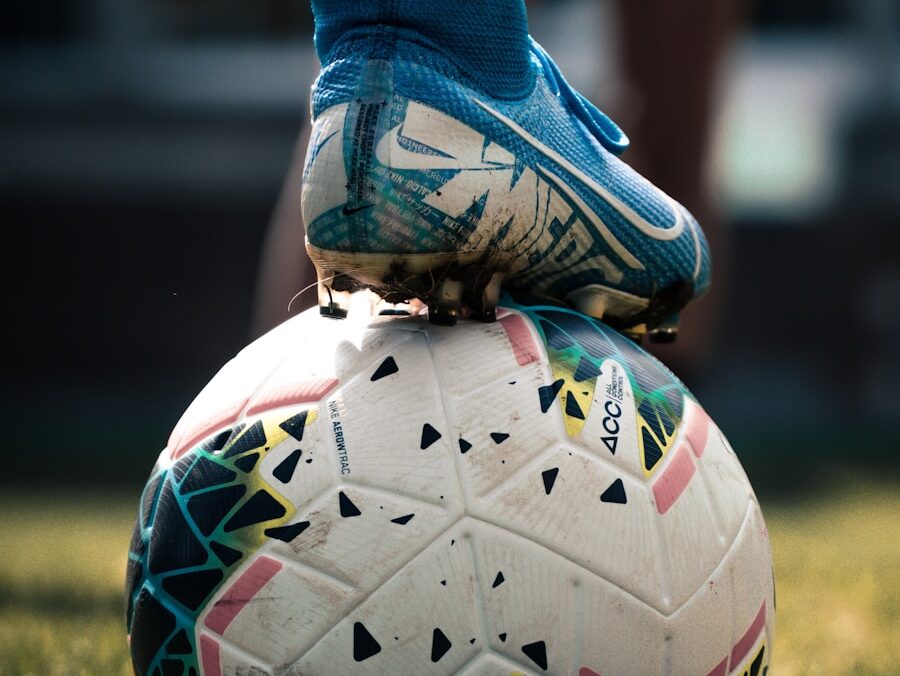 white and blue soccer ball on green grass field