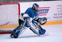 ice hockey goalie defending the goal