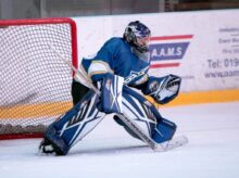 ice hockey goalie defending the goal