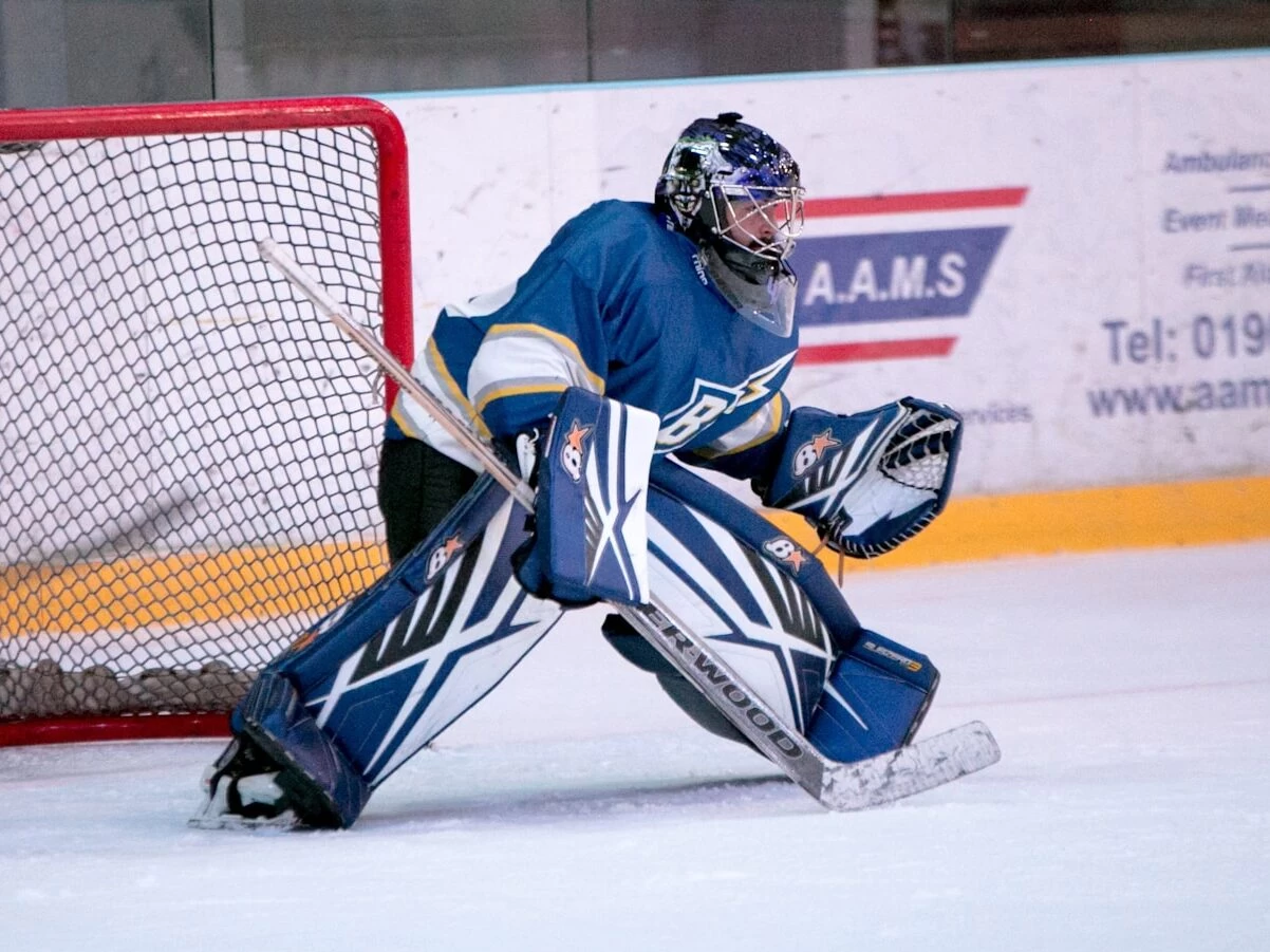 ice hockey goalie defending the goal
