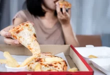 Žena, která v rychlosti konzumuje pizzu