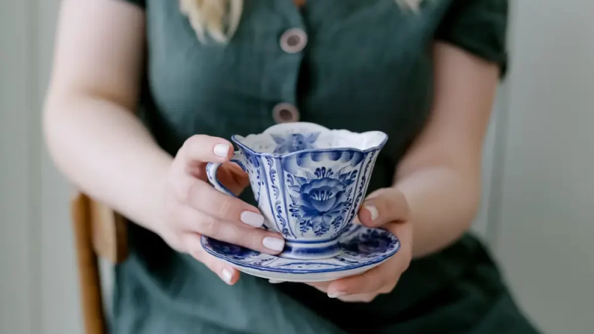 žena držící porcelánový šálek