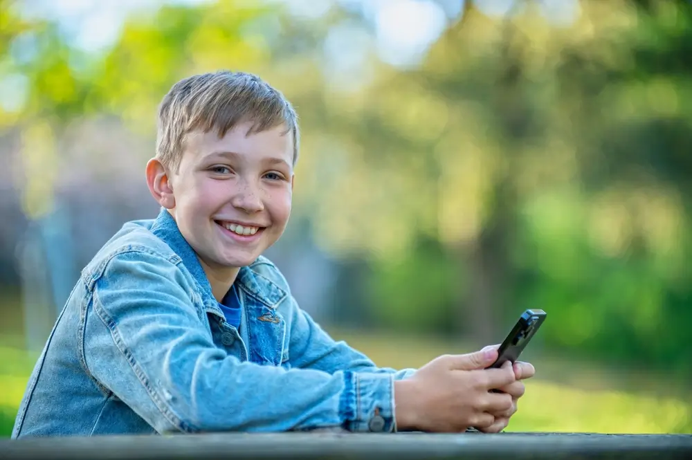 shutterstock_2516751463 - SportDeník dítě s telefonem