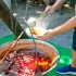 Muž v zástěře vaří kotlíkový guláš na ohni