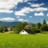 Pohled na Beskydy v oblasti Těšínska, slunečný den, v pozadí kostelík a vesnička