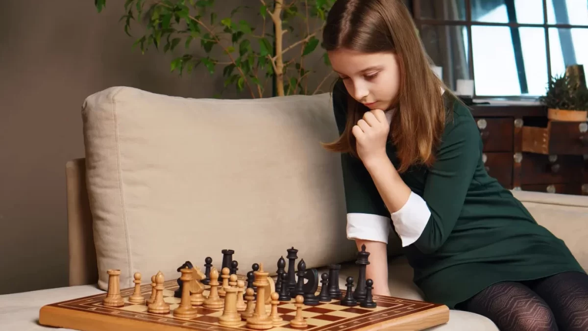 dívka přemýšlí nad šachama