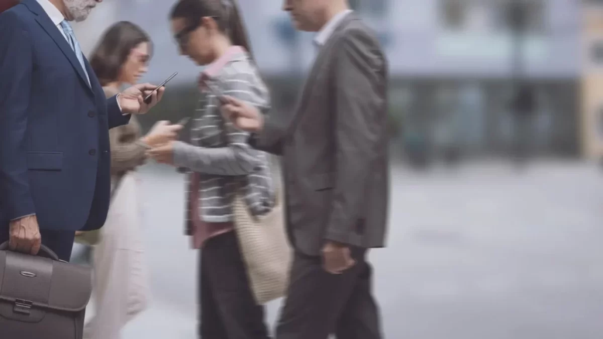 Lidé na ulici s mobilními telefony v ruce.