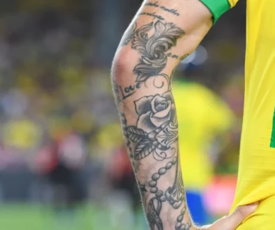 Detail ruky fotbalisty s tetováním.