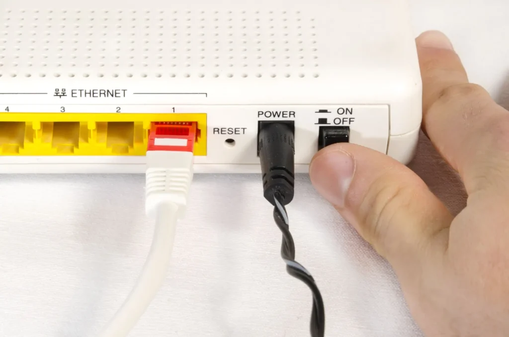 Ruka vypínající Wi-Fi router