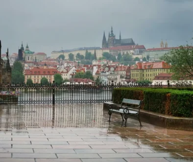 Pražský hrad a město pod deštivou a zataženou oblohou.