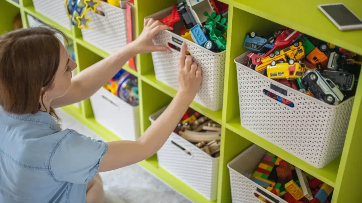 Učitelka v mateřské školce popisuje v šatně přihrádky dětem