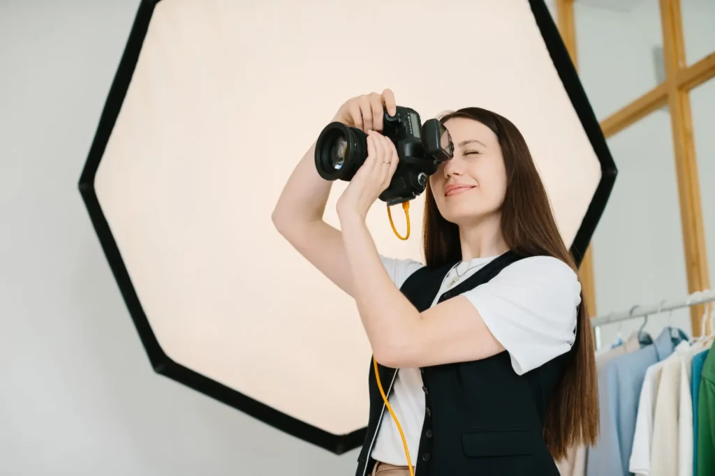Žena koukající do fotoaparátu v ateliéru